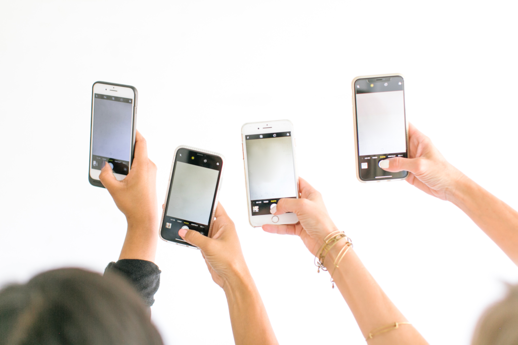 Woman holding her phone deciding what to post on social media